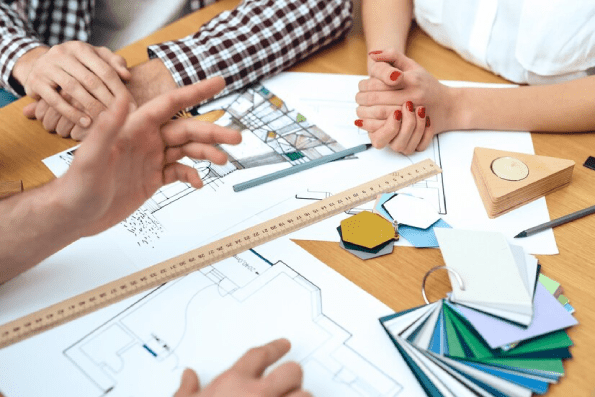 Group of designers architects discuss project. Group of designers architects discuss project.